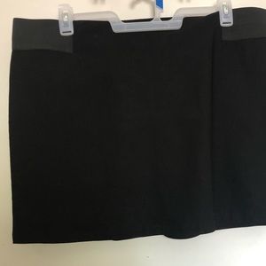 Plus size black mini skirt with elastic waistband.